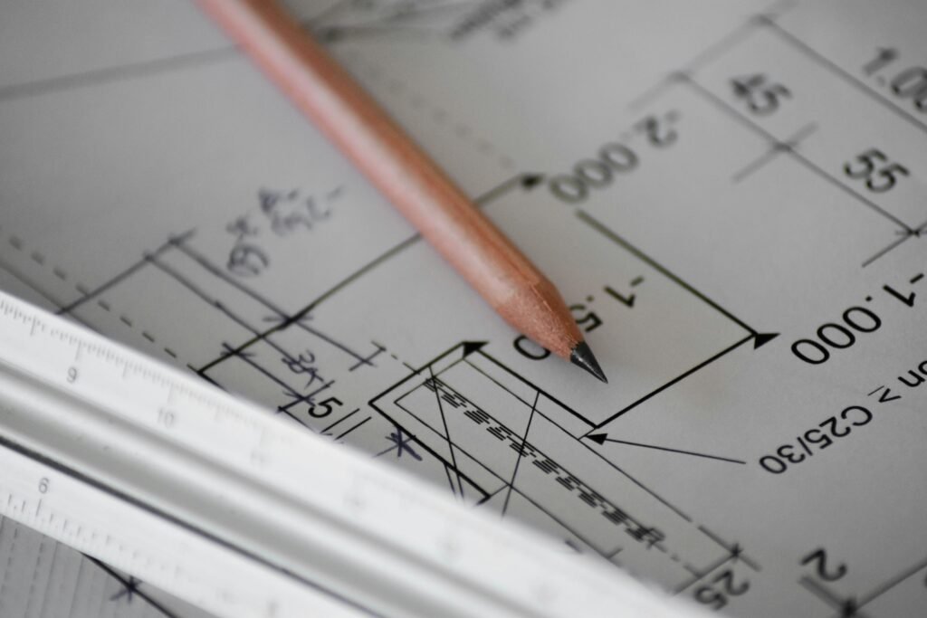 Estimator's desk with architectural blueprints, a calculator and cost sheets